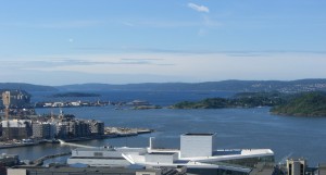 a body of water with buildings and islands in the background