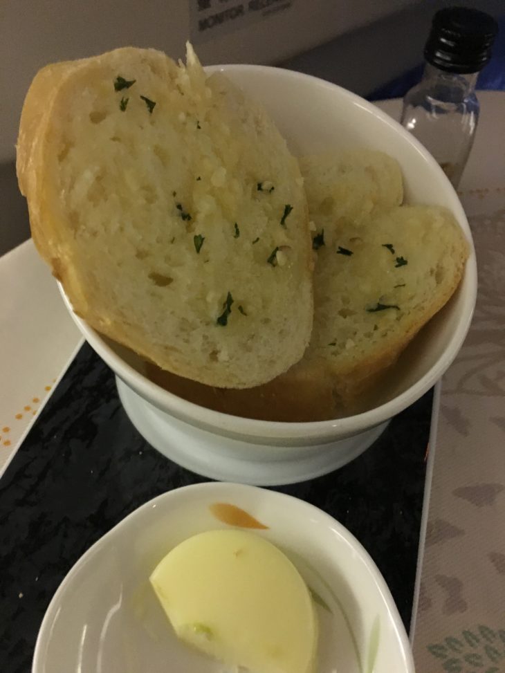 a bowl of bread with butter and butter on a table