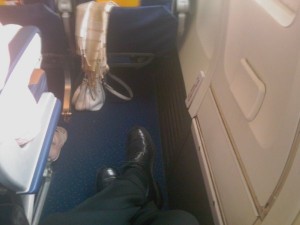 a person's legs on a plane