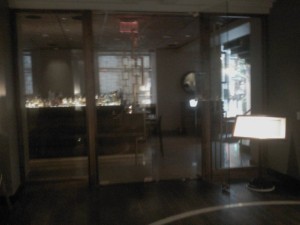 a glass door with a lamp in front of it