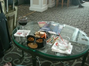 a glass coffee table with food and drinks on it