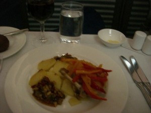 a plate of food and a glass of wine