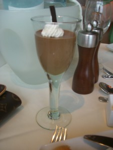 a glass of chocolate pudding with whipped cream
