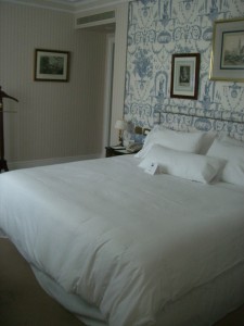 a bed with white sheets and pillows