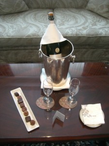 a champagne bottle in a bucket and two glasses