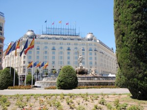 a large white building with many flags