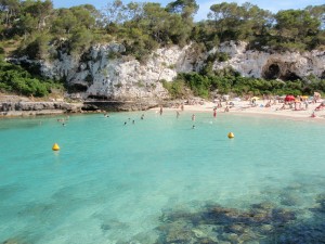 a group of people swimming in a clear blue water