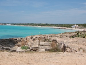 a sandy beach with blue water