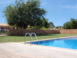 a swimming pool with a wooden deck