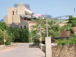 a building with a roller coaster in the background