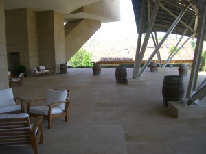 a patio with chairs and barrels