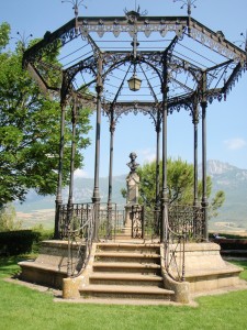 a gazebo with a statue in the middle