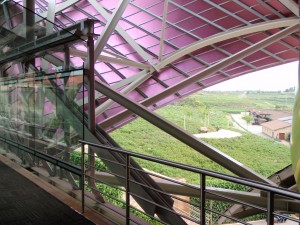 a glass railing and metal structure