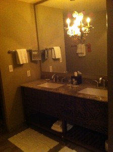 a bathroom with a chandelier and sink