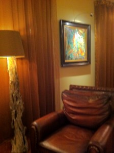 a lamp and a painting on the wall