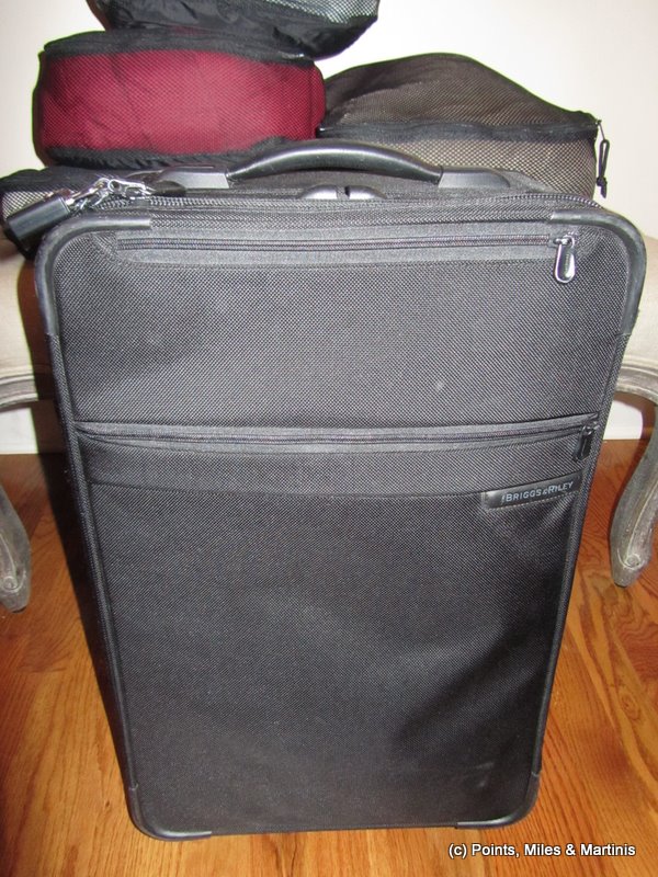 a black suitcase on a wood floor