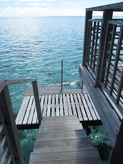 a wooden dock with stairs leading to the water
