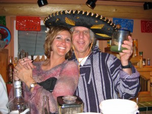 a man and woman wearing sombrero holding a candle