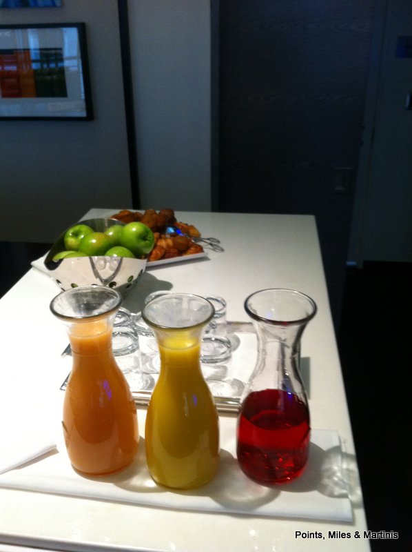 a group of juices and fruit on a table