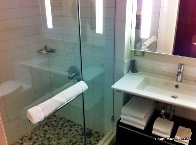 a bathroom with a glass shower door