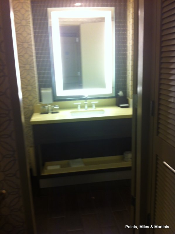 a bathroom with a lighted mirror