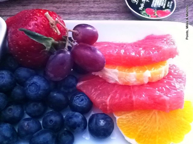 a plate of fruit and grapes
