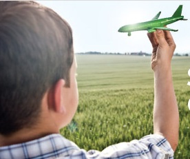 a boy holding a toy airplane