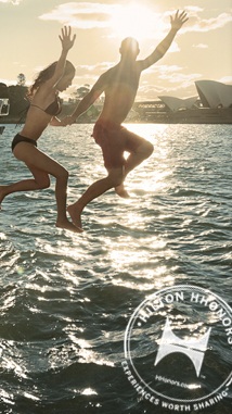 a man and woman jumping into water