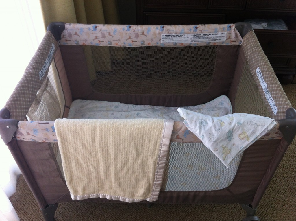 a baby crib with blankets