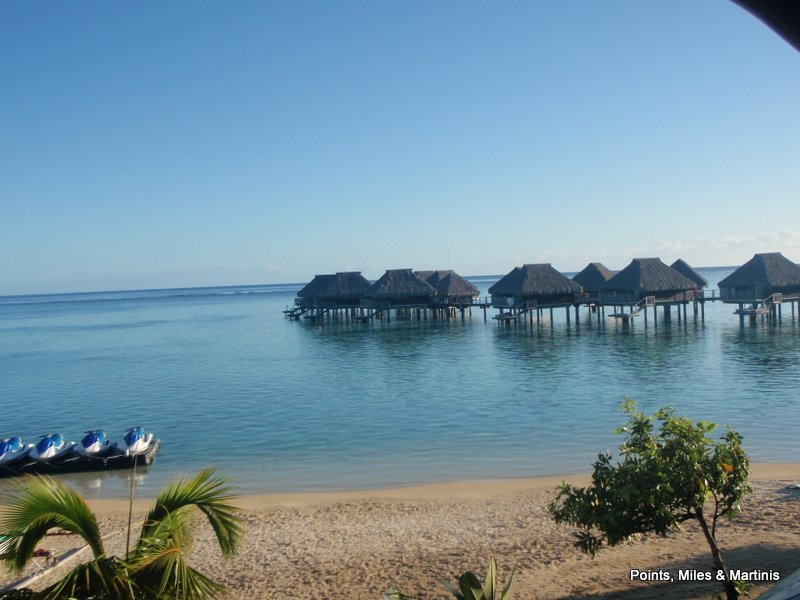 a group of huts on stilts in the water