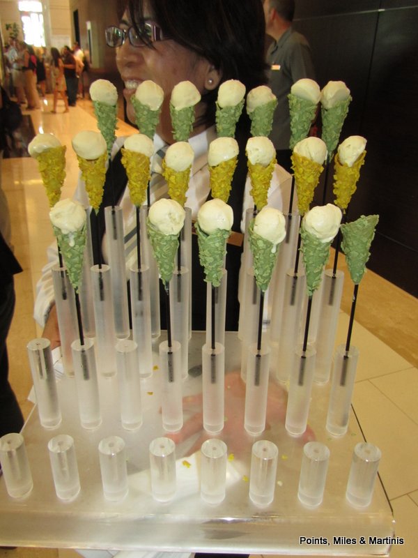 a woman smiling at a display of ice cream cones