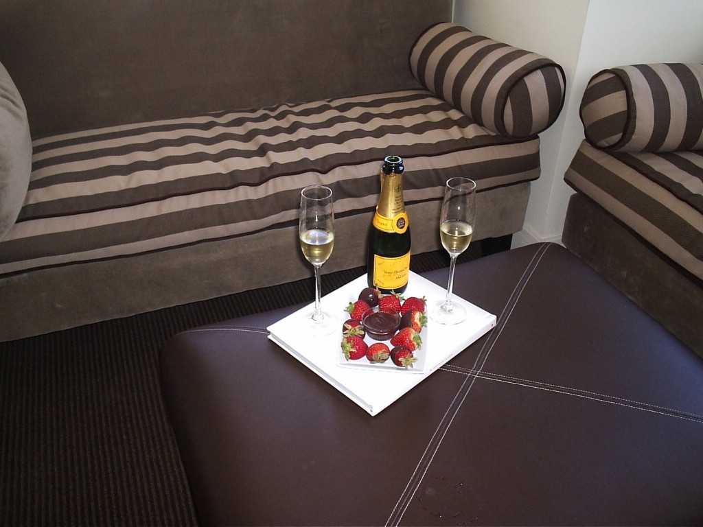 a champagne and strawberries on a tray