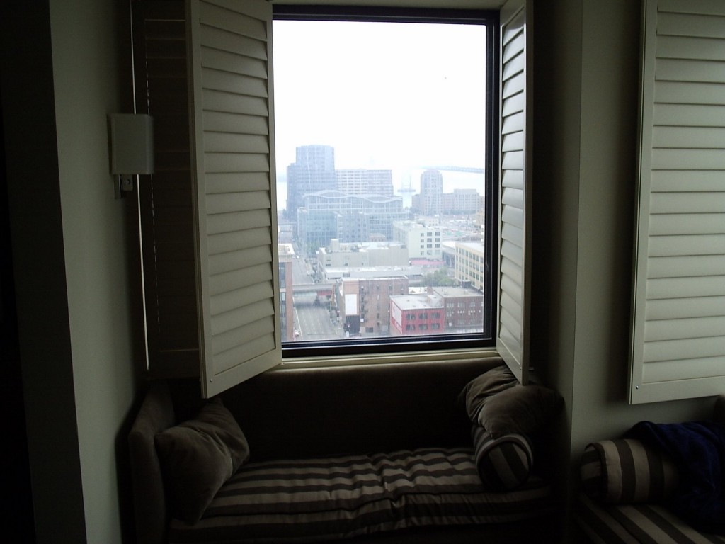 a window with a couch and pillows