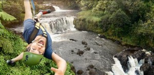 a man in front of a waterfall