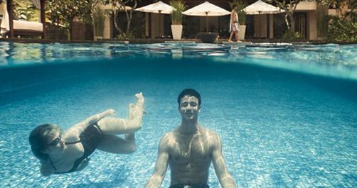 a man and woman in a swimming pool