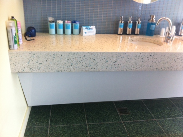 a bathroom counter with soap dispensers and bottles