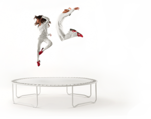 a woman jumping on a trampoline