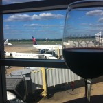 a glass of wine in front of an airport
