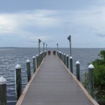 a long dock with chairs on it