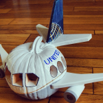 a carved pumpkin with a plane on the side