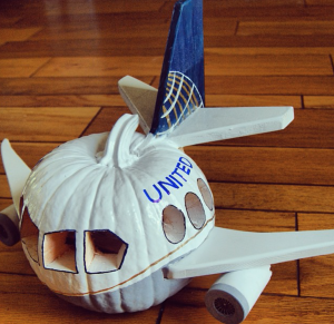 a carved pumpkin with a plane on the side