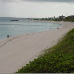 a beach with people walking on it