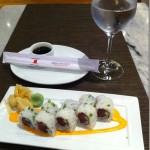 a plate of sushi and a glass of water