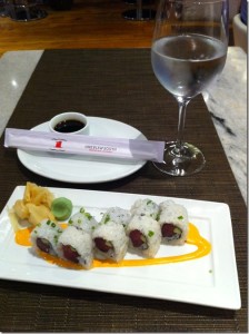 a plate of sushi and a glass of water