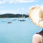 a woman looking at boats in the water