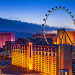 a large building with a ferris wheel in the background