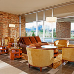 a room with a couch and chairs