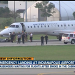 a plane with emergency personnel and emergency vehicles