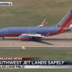 a blue and red airplane on a runway