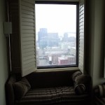 a window with a couch and pillows